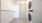 Closet with shelves and stacked washer dryer