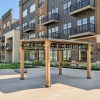 Pergola and grills in front of apartment building