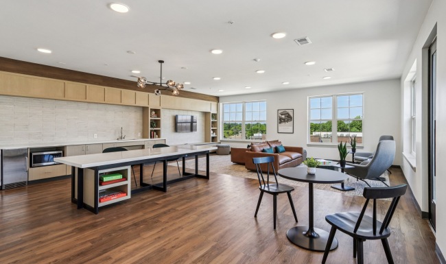 Large room with tables and kitchen