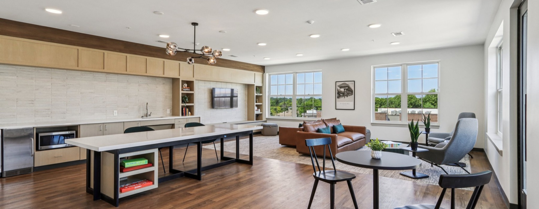 Large room with tables and kitchen