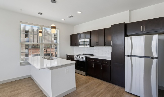 Kitchen with island and brown cabinets
