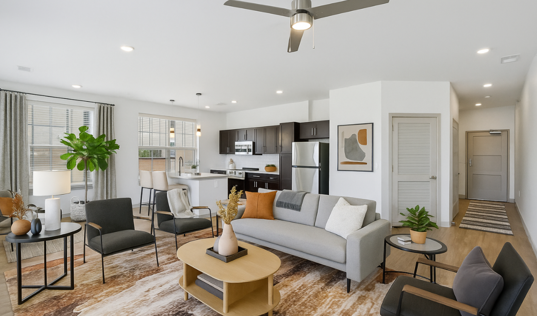 Staged apartment with view of hallway and kitchen